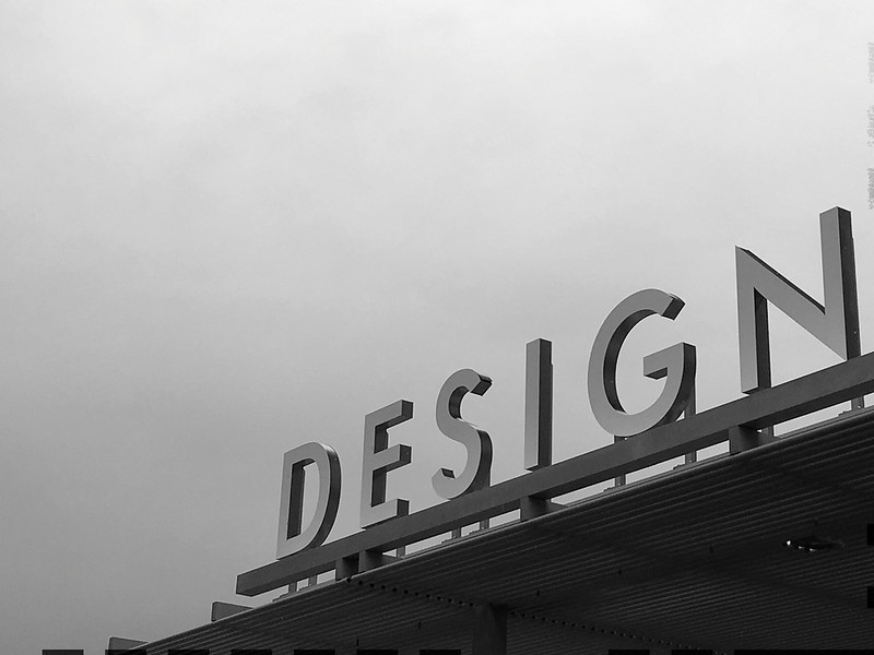 Black and white picture of a sign saying DESIGN
